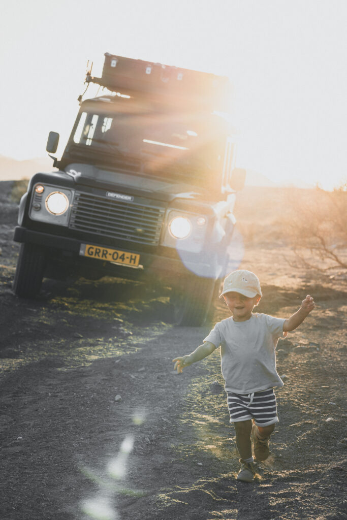 Quinn running in front of the Land Rover Defender